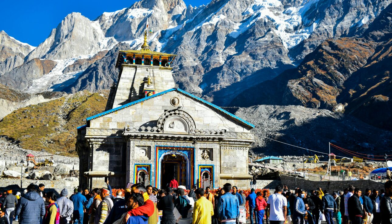 Chardham Yatra 2025 – 9 Days Divine Himalayan Journey 1 Crowd gathers at Kedarnath Temple with Himalayas backdrop, showcasing religious significance and stunning landscape.